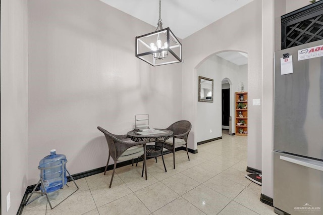3908 Hill Crest Dr, Mission, TX 78573 - dining area with arched walkways, a chandelier, and light tile patterned floors