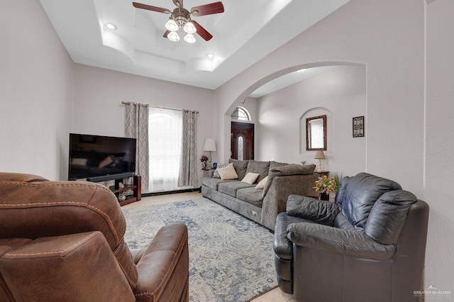 3908 Hill Crest Dr, Mission, TX 78573 - living room featuring arched walkways, a ceiling fan, a raised ceiling, and light carpet