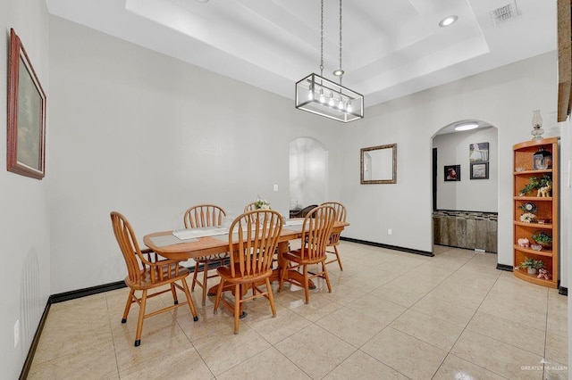 3908 Hill Crest Dr, Mission, TX 78573 - dining space with arched walkways, a raised ceiling, recessed lighting, and light tile patterned floors