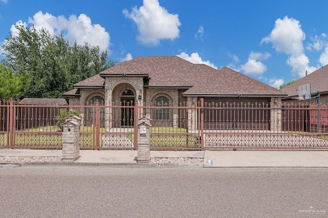 3908 Hill Crest Dr, Mission, TX 78573 - view of front of house with roof with shingles, a fenced front yard, brick siding, an attached garage, and driveway