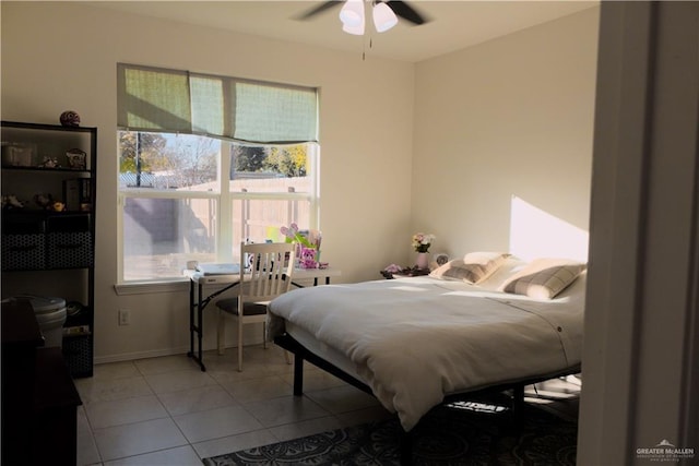 tiled bedroom featuring ceiling fan