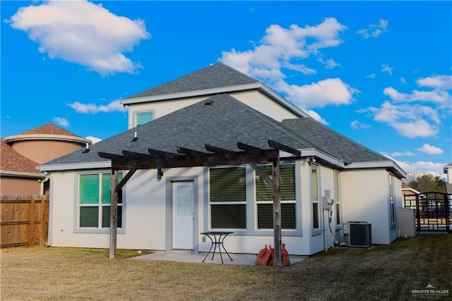 rear view of property featuring central AC, a yard, a pergola, and a patio area