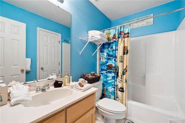 full bathroom featuring tile patterned floors, shower / bath combo with shower curtain, vanity, and toilet