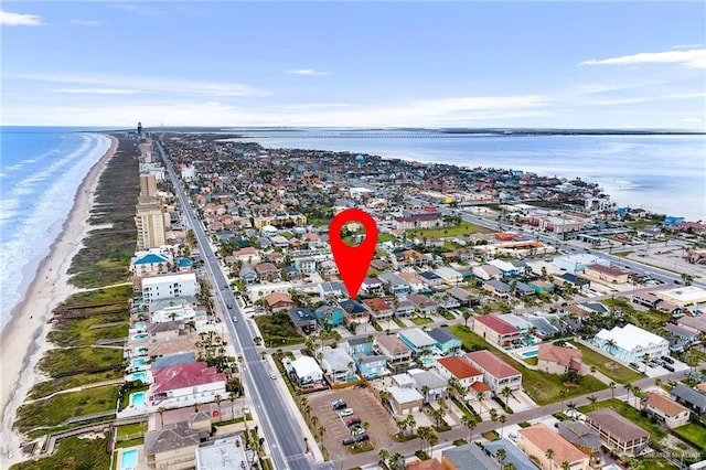 bird's eye view with a water view and a beach view