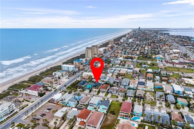 bird's eye view featuring a water view and a beach view