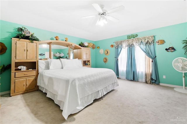 bedroom featuring ceiling fan and light carpet