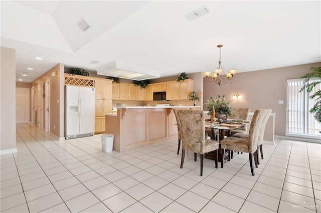 kitchen featuring an inviting chandelier, white refrigerator with ice dispenser, pendant lighting, vaulted ceiling, and light brown cabinetry