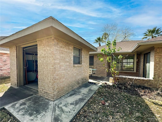 view of property exterior featuring brick siding