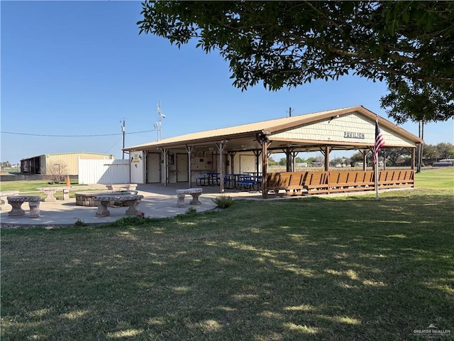 surrounding community with fence, a lawn, and a patio area