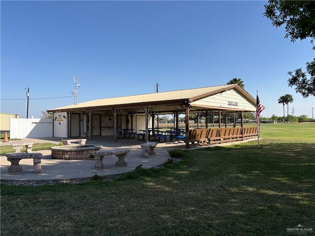 view of community with a patio area, a lawn, and fence