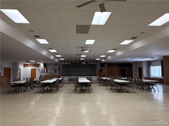 dining area with tile patterned floors, visible vents, a paneled ceiling, and ceiling fan