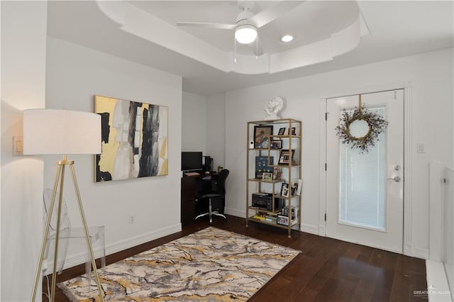 entryway featuring dark hardwood / wood-style floors, a raised ceiling, and ceiling fan