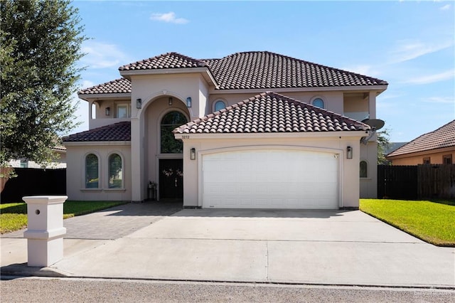 mediterranean / spanish-style house with a garage