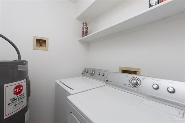 clothes washing area featuring washing machine and dryer and electric water heater