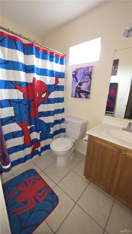2216 N 48th St, Mcallen, TX 78501 - bathroom featuring vanity, tile patterned floors, toilet, and a shower with curtain