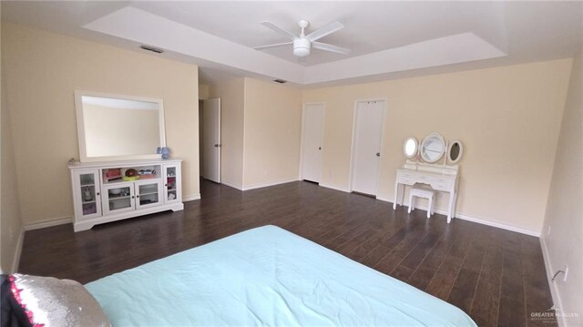 2216 N 48th St, Mcallen, TX 78501 - bedroom with visible vents, baseboards, wood finished floors, and a tray ceiling