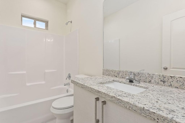 bathroom featuring toilet, shower / bathtub combination, and vanity