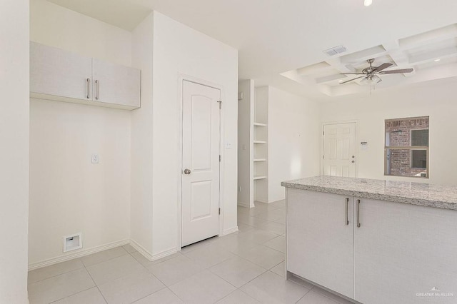 kitchen featuring coffered ceiling, a ceiling fan, light tile patterned flooring, beam ceiling, and baseboards