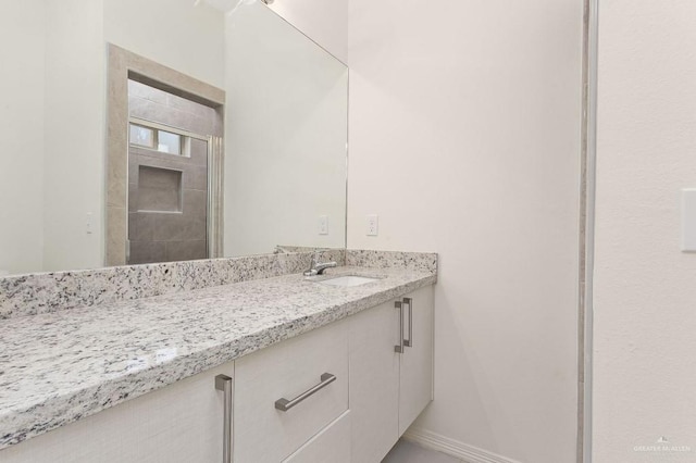 bathroom featuring vanity and baseboards
