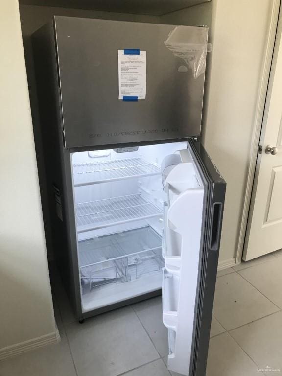detailed view of fridge and baseboards