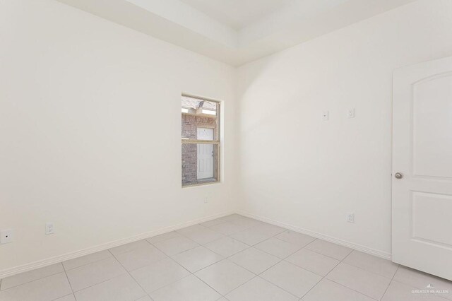 spare room with baseboards