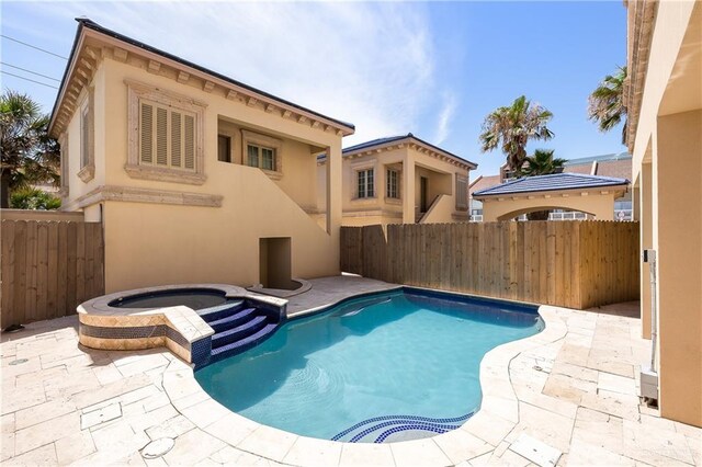 4616 Gulf Blvd S, Unit South, South Padre Island, TX 78597 - view of swimming pool featuring a fenced backyard, a patio, and a pool with connected hot tub