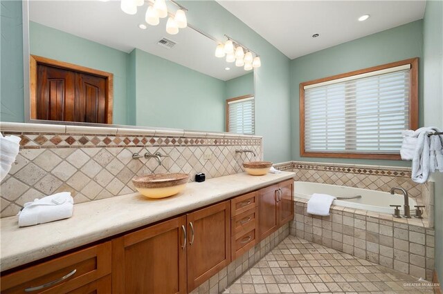 4616 Gulf Blvd S, Unit South, South Padre Island, TX 78597 - bathroom featuring double vanity, a bath, and tile patterned floors