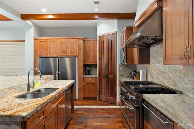 4616 Gulf Blvd S, Unit South, South Padre Island, TX 78597 - kitchen with appliances with stainless steel finishes, a sink, range hood, dark wood-style flooring, and backsplash