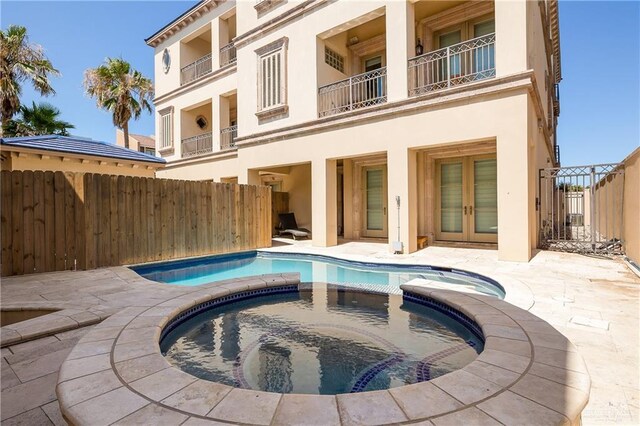 4616 Gulf Blvd S, Unit South, South Padre Island, TX 78597 - view of swimming pool with a fenced backyard, a pool with connected hot tub, french doors, and a patio