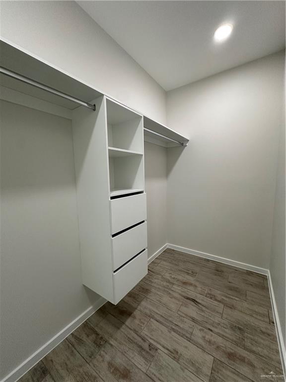 walk in closet featuring dark hardwood / wood-style flooring