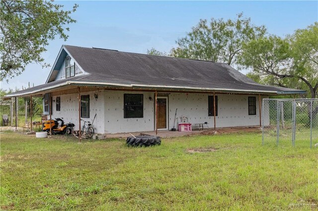 rear view of property with a lawn