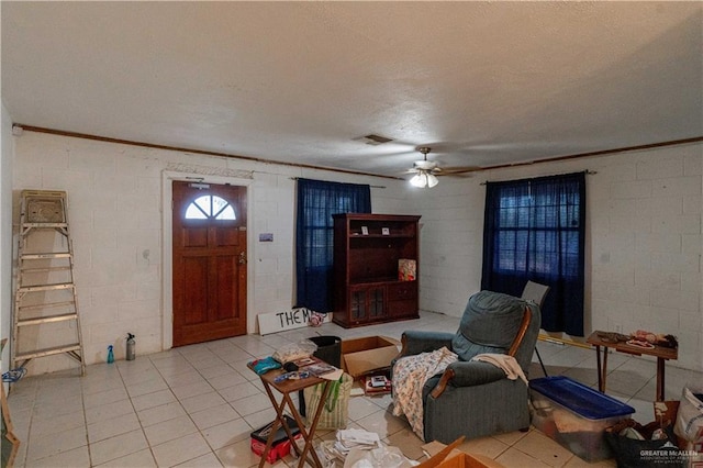 living room with ceiling fan and light tile patterned flooring