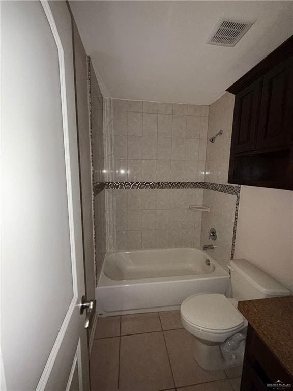 full bathroom with toilet, vanity, tile patterned flooring, and tiled shower / bath combo