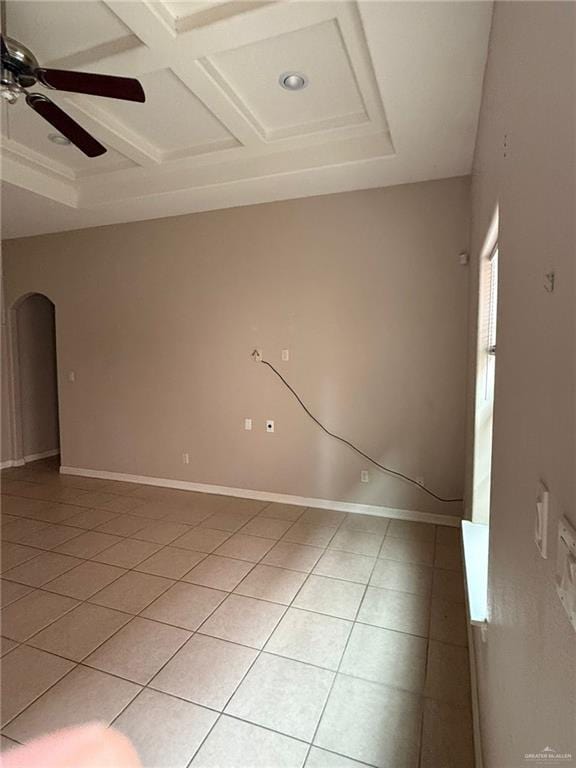 unfurnished room with ceiling fan, light tile patterned floors, and coffered ceiling