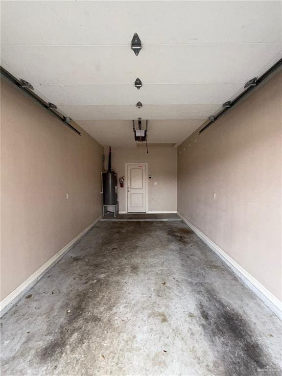 garage featuring water heater and a garage door opener