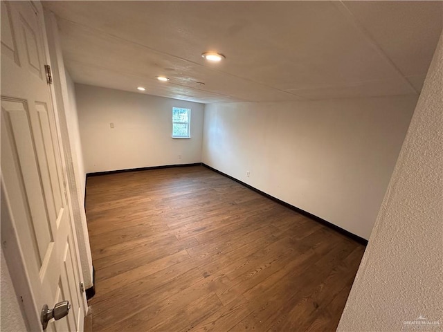 interior space with baseboards, dark wood-style flooring, and recessed lighting