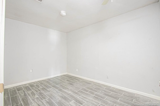 empty room with ceiling fan and light wood-type flooring