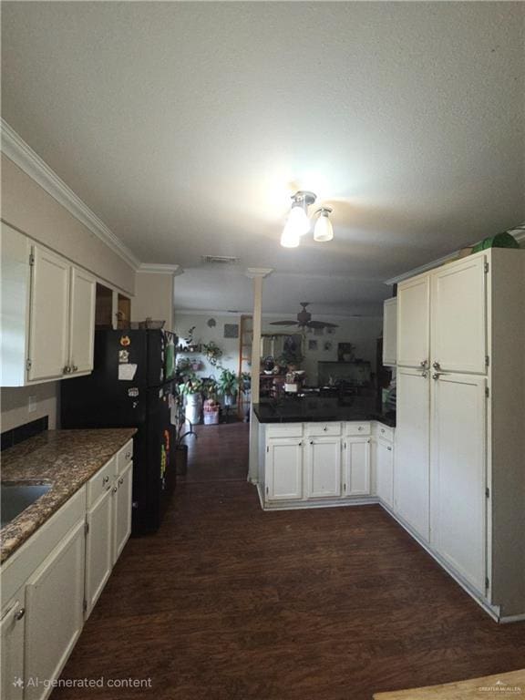 kitchen featuring ornamental molding, dark wood finished floors, white cabinets, and freestanding refrigerator