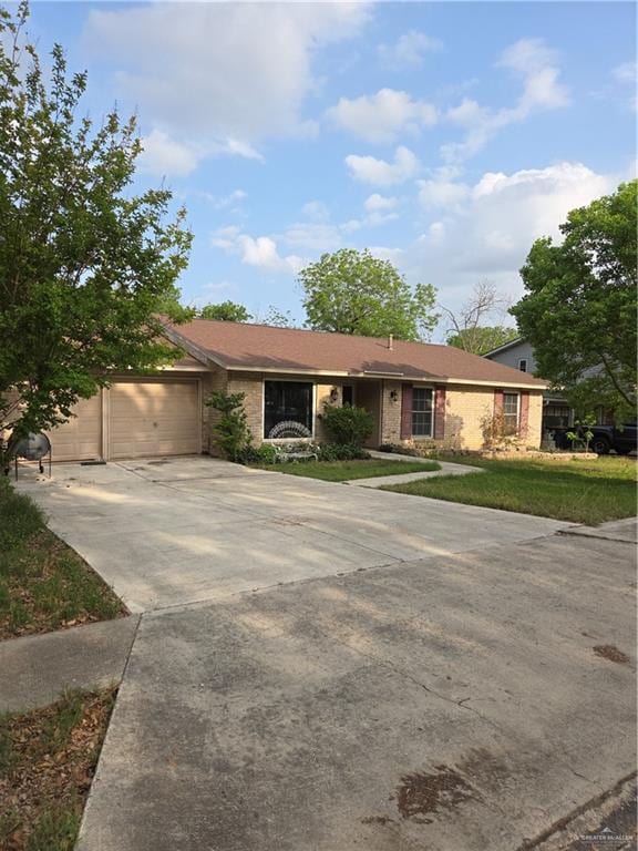 ranch-style house featuring an attached garage and driveway