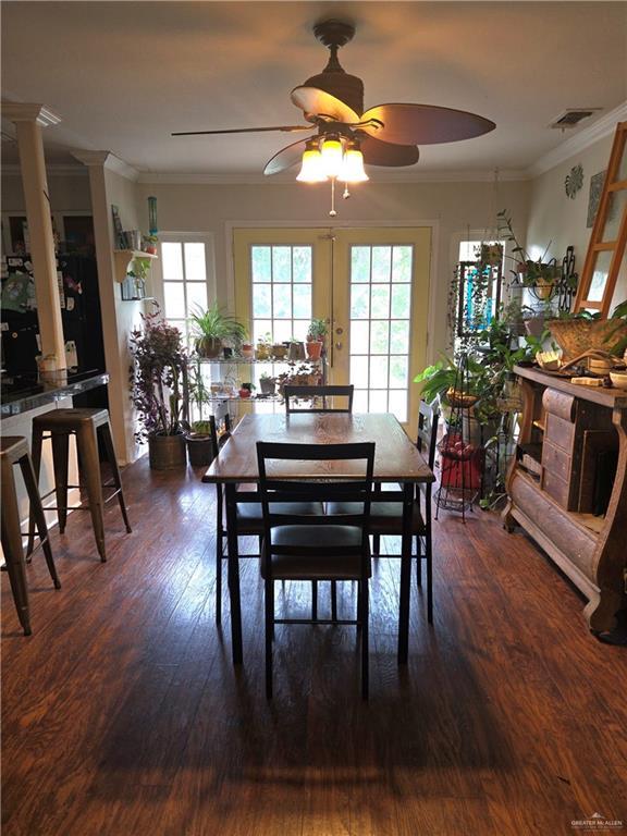 dining room with ceiling fan, visible vents, ornamental molding, and wood finished floors