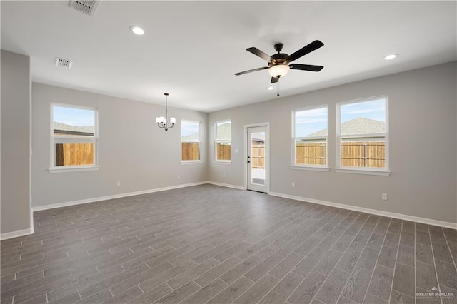 unfurnished living room with dark wood-style flooring, visible vents, and a wealth of natural light