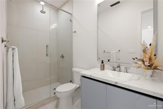 bathroom featuring vanity, an enclosed shower, and toilet