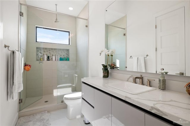 bathroom with a shower with door, vanity, and toilet