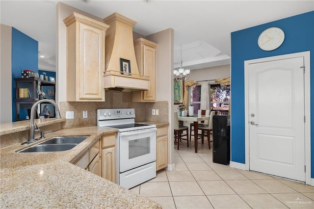 kitchen featuring electric range, sink, light brown cabinets, a notable chandelier, and custom exhaust hood