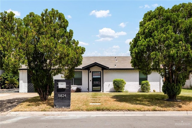 5824 N 23rd Ln, Mcallen, TX 78504 - view of front of home featuring brick siding, a front yard, and driveway