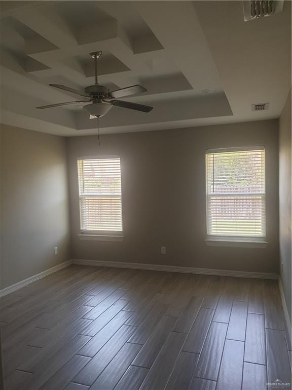 7612 N 40th St, Mcallen, TX 78504 - empty room featuring wood finished floors, a ceiling fan, a raised ceiling, and baseboards