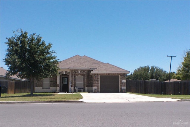 7612 N 40th St, Mcallen, TX 78504 - view of front of home featuring a garage, driveway, brick siding, and fence