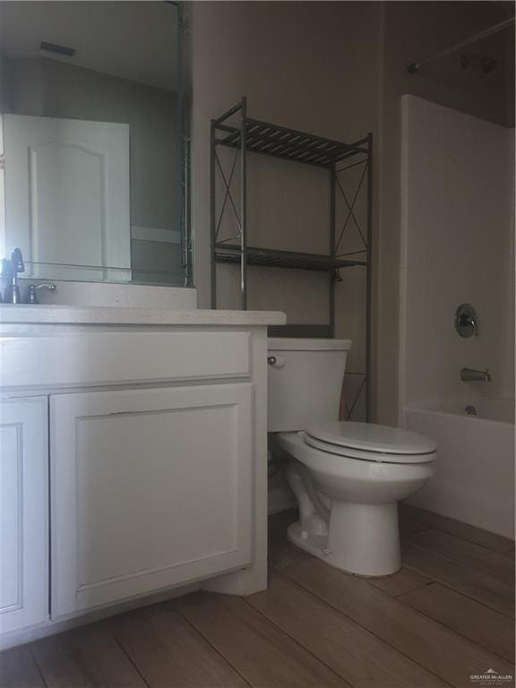 7612 N 40th St, Mcallen, TX 78504 - full bath featuring toilet, vanity, wood finished floors, and shower / bathtub combination