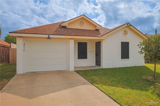 ranch-style house featuring a front yard and a garage