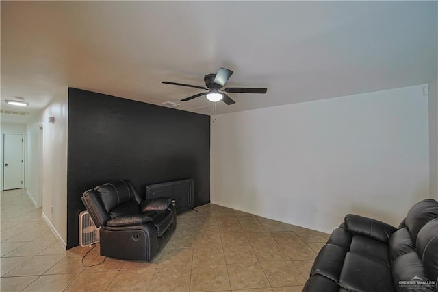 tiled living room with ceiling fan